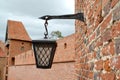 A suspended lantern against the background of a watchtower. Cathedral complex. Frombork, Poland Royalty Free Stock Photo