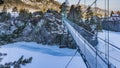 A suspended metal bridge leads to a secluded monastery Royalty Free Stock Photo