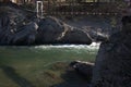 Suspended pedestrian bridge over a stormy mountain river. Altai, Siberia, Russia. Landscape Royalty Free Stock Photo