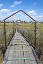 Suspended pedestrian bridge over the Yaya River in the village of Nasha Rodina Royalty Free Stock Photo