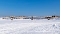 Suspended wooden bridge across a frozen river in a Russian village Royalty Free Stock Photo