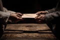 Secretive Envelope Exchange Under Rustic Table in Suspenseful Office Setting Royalty Free Stock Photo