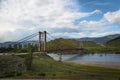 Suspension bridge across mountain river Royalty Free Stock Photo