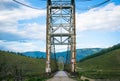 Suspension bridge across mountain river Royalty Free Stock Photo