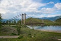 Suspension bridge across mountain river Royalty Free Stock Photo