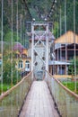 Suspension bridge across mountain river Katun. Altai, Siberia Royalty Free Stock Photo