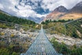 Suspension bridge and beautiful himalayan mountains at sunset