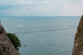 Suspension bridge hanging above the sea between two cliffs Royalty Free Stock Photo