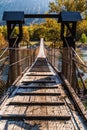 Suspension bridge over a mountain river in a gorge Royalty Free Stock Photo