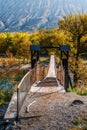 Suspension bridge over a mountain river in a gorge Royalty Free Stock Photo