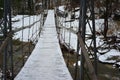 Suspension bridge over the mountain river