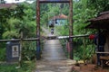 Suspension bridge over the river with motorcycle crossing on it in the morning in Sukabumi, west java, Indonesia. traditional