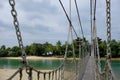 Suspension bridge leading from Palawan Beach in Sentosa Island, Singapore, to `the Southernmost point of Continental Asia`