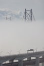 Suspension bridge in thick dense white fog