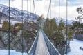 Suspension bridge to John Baptist skete Barnaul Znamensky women monastery in Patmos village of Chemal in winter.