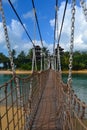 Suspension bridge on tropical island. Sentosa island, Singapore. Sea scenery. Royalty Free Stock Photo