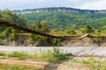 Suspension cable bridge, Crossing the river. Adygea republic, Krasnodar region, Russia Royalty Free Stock Photo