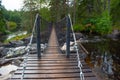 Suspension cable bridge crossing the river Royalty Free Stock Photo