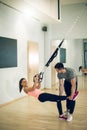 Suspension exercise with personal trainer.