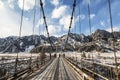 Suspension road bridge over Katun in the Chemalsky district of the Altai Republic in winter