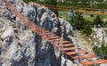 Suspension rope ladder in mountains over the chasm