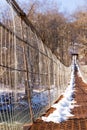 Suspention bridge over the mountain river winter view. Royalty Free Stock Photo