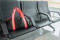 Suspicious black sport bag left on chairs unattended. Lost luggage. Concept of safety in public places and terrorism