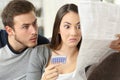 Suspicious couple reading a leaflet after taking contraceptive pills