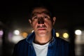 Suspicious-looking Hispanic man in dark parking lot Royalty Free Stock Photo