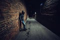 Suspicious man in dark alley waiting for something. Royalty Free Stock Photo