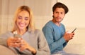 Suspicious Man Watching Girlfriend Texting On Phone Sitting At Home Royalty Free Stock Photo