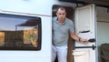 Suspicious travel man walks out of camper van to uninvited guests. Road Conflict