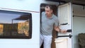 Suspicious travel man walks out of camper van to uninvited guests. Road Conflict