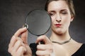 Suspicious woman looking at her wedding ring through magnifying glass Royalty Free Stock Photo