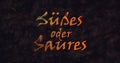 Susses oder Saures (Trick or Treat) German text dissolving into dust from left Royalty Free Stock Photo