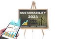 2023 sustainability on chalkboard and online financial technology or fintech on smartphone on white background Royalty Free Stock Photo