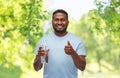 Happy african man with water in glass bottle Royalty Free Stock Photo