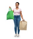 woman comparing reusable and paper bags