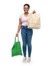 woman comparing reusable and paper bags