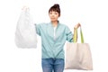 woman comparing reusable tote and plastic bags