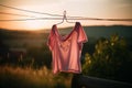 Sustainable clothes. Pink female t-shirt hanging outside to dry. Royalty Free Stock Photo