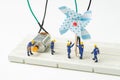 Sustainable energy, alternative clean eco power concept, miniature people worker help building windmill electricity generator to