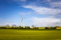 Sustainable energy. Danish landscape with windmills and green fields. Royalty Free Stock Photo