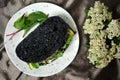 Sustainable green diet conceptual image with black charcoal bread and veggie sandwich