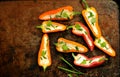 Still life photography with mini bell peppers and goat cheese on a tray Royalty Free Stock Photo