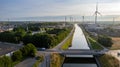 Sustainable Pathways: Aerial View of a Canal and Wind Turbines