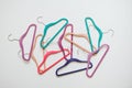 Sustainable responsible consumption concept. Many bright multi-colored velvet pop color hangers on white background. Store, sale,