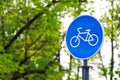 Sustainable transport. Blue road sign or signal of bicycle lane Royalty Free Stock Photo