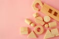 Sustainable Wooden Educational Toys on Soft Pink Background for Creative Play. Royalty Free Stock Photo