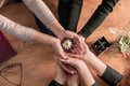 Group of business hands holding a fresh young sprout. Symbol of growing and green business